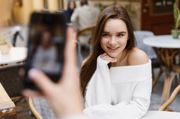 girls taking photos to each other at the cafe