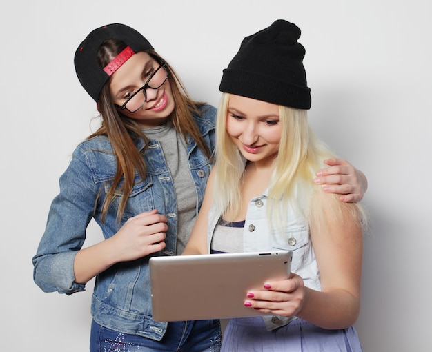 Girls taking a self portrait with a tablet