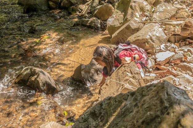 Girls walking up a mountain stream.