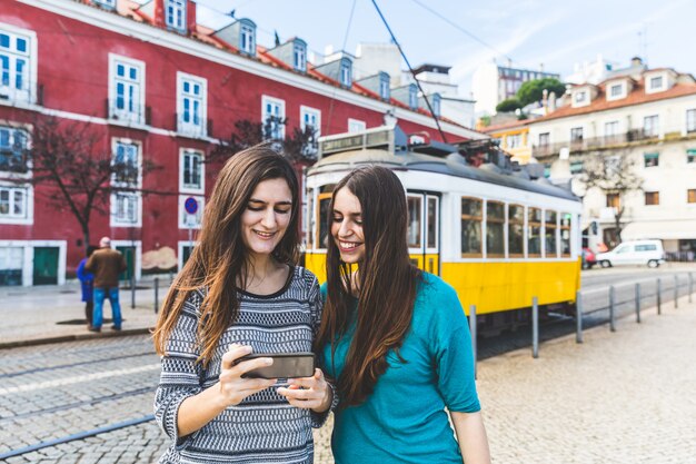 Girls with smartphone in Lisbon