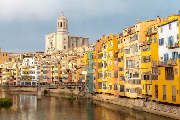 Girona medieval city, basilica and the cathedral next to the colored houses on the Onyar river, Costa Brava of Catalonia in the Mediterranean. Spain