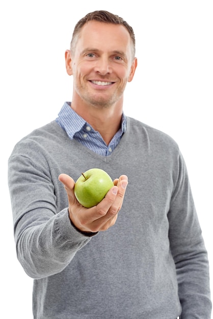 Giving apple studio portrait and man with fruit for health diet and wellness isolated on a white background Model person with nutrition vegan food in hand for healthy lifestyle and clean eating