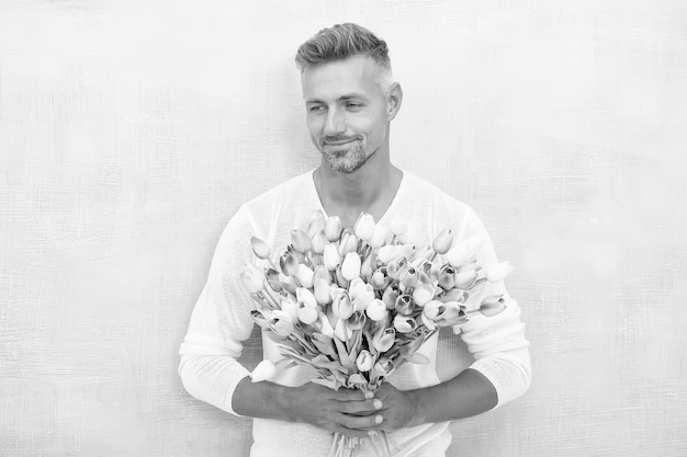 Giving her all best Valentines day and anniversary How to be romantic Romantic gentleman Man mature confident macho with romantic gift Handsome guy flowers bouquet romantic date Fresh tulips