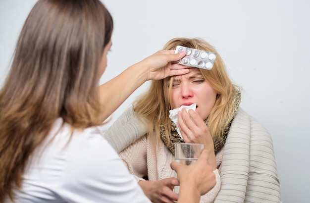 Giving medicine Medical doctor examining patient Patient care and healthcare Primary care doctor making diagnosis to sick woman Doctor visiting unhealthy woman at home