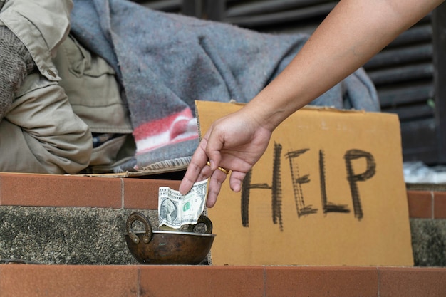 Photo giving money to homeless men on the side of the road.