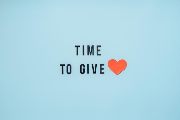 Giving tuesday time to give help donation support volunteer concept with red heart and text time to