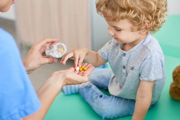 Giving Vitamins to Curly Little Patient