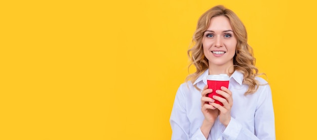 Glad blonde woman with morning coffee cup on yellow background Woman isolated face portrait banner with mock up copy space