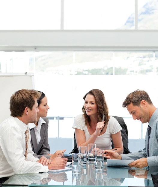 Glad businesswoman talking to her team