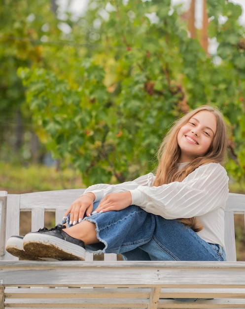 Glad child sit on bench outdoor relaxation