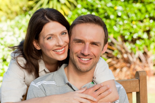 Glad couple hugging in the garden