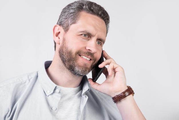 Glad man has communication call on phone isolated on studio background