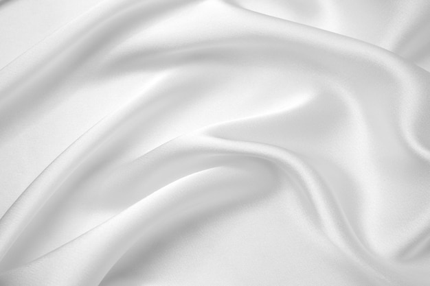Gladde elegante witte zijde of satijn luxe doek textuur kan gebruiken als bruiloft achtergrond Luxe achtergrondontwerp