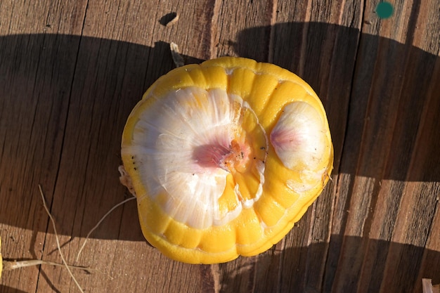 Gladiolus bulb on a wooden table on straight hard sunlight Top view