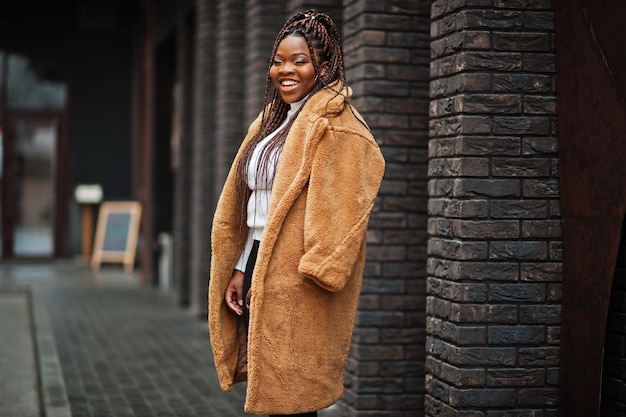 Glamorous african american woman in warm fur coat pose at street