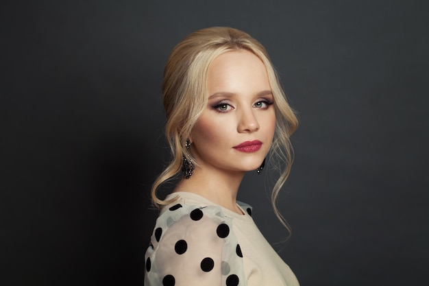 Glamorous woman with blonde hair and makeup portrait