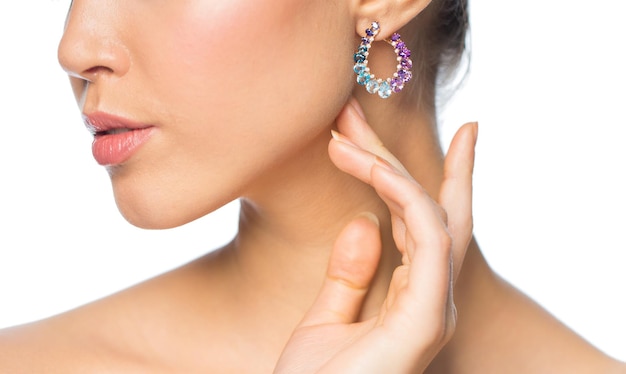 glamour, beauty, jewelry and luxury concept - close up of beautiful woman face with earring