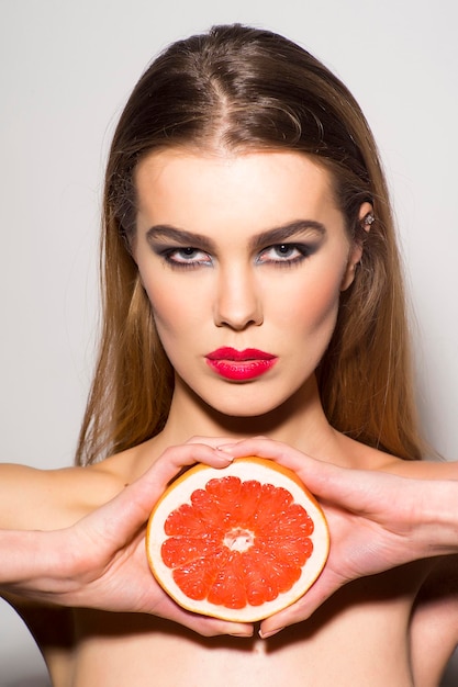 Glamour girl holding grapefruit