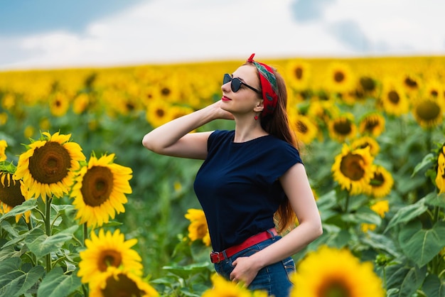 Glamour pinup girl on the sunflowers field