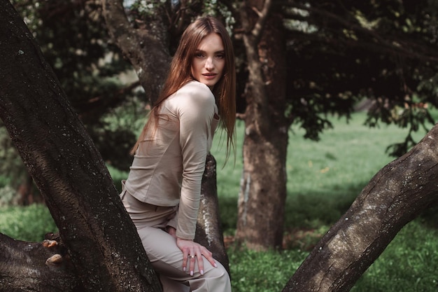 Glamour young lady poing in the green forest