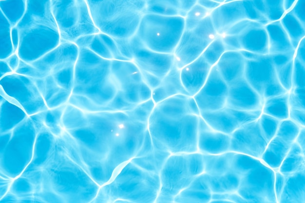 Glare on the blue water in the pool closeup