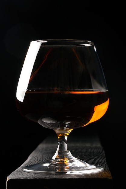 Glas cognac op de zwarte tafel