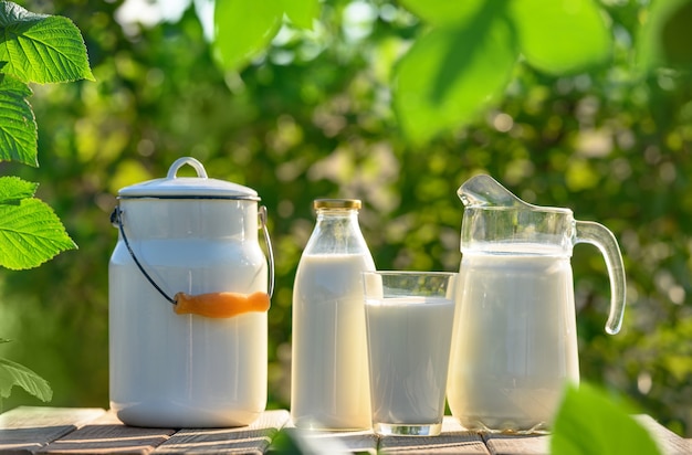 Glas en kruik verse melk op houten tafel