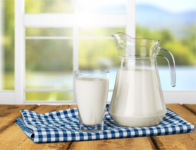 Glas melk en fles op achtergrond