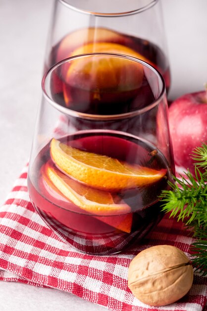 Glases of Tasty Mulled Wine with Oranges and Spices on Napkin Tasty Christmas Drink Vertical