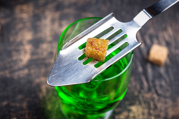 Glass of absinthe with cane sugar