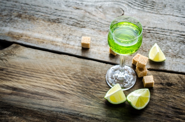 Glass of absinthe with lime and sugar cubes