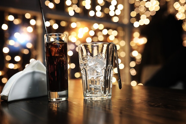 Glass of alcohol with ice on blured background with circle bokeh