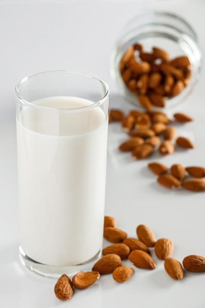 A glass of almond milk on a white background. Lactose-free vegetable diet milk.