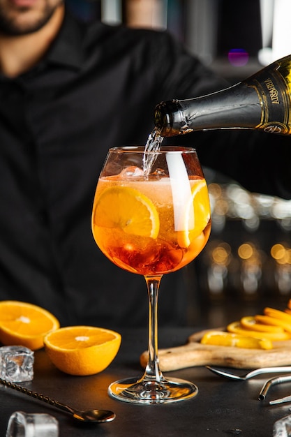 Glass of aperol spritz cocktail with orange peel Spritz cocktail and on dark background