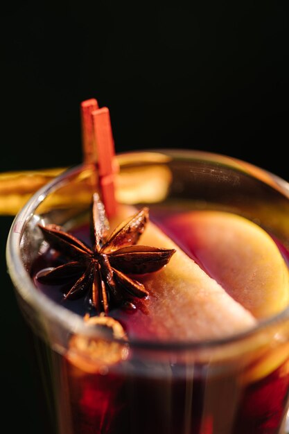 A glass of apple cider with anise star on it