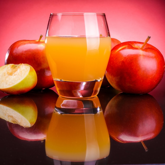 Glass of apple juice with apples