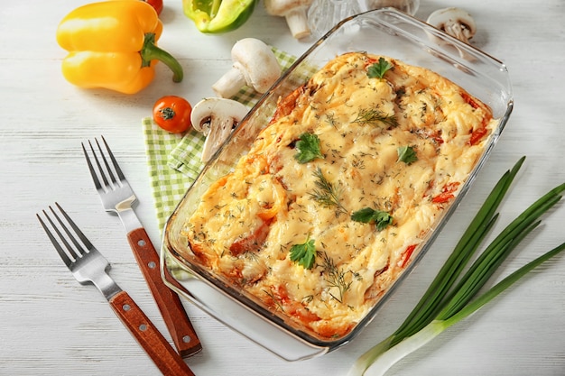 Glass baking dish with delicious casserole on table. Fresh from oven