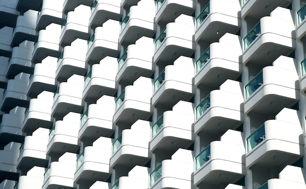 Glass balconies on modern building facade, architecture background. Real estate, property, house. Construction, architecture, design, decor, exterior.