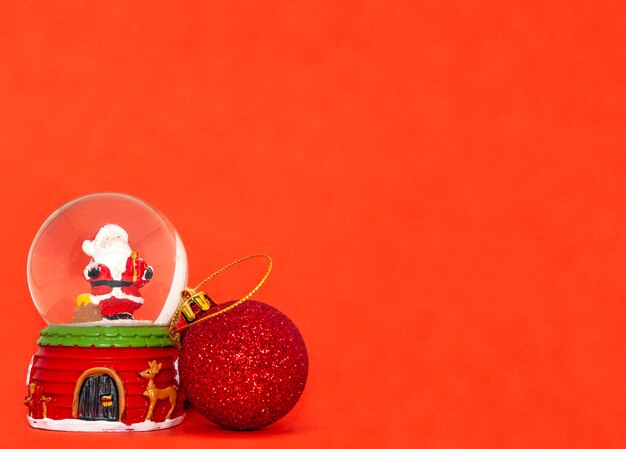 Photo glass ball with santa claus on a red background for the holiday merry christmas