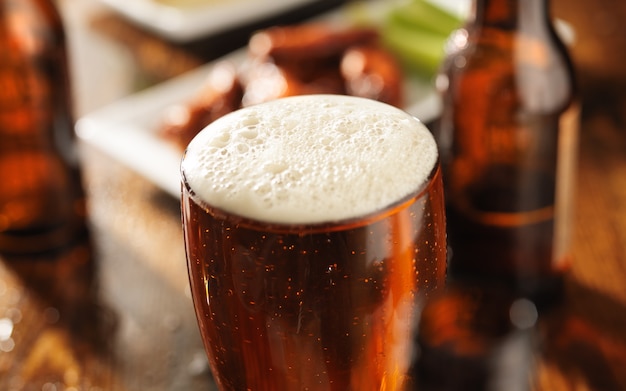 Glass of beer and barbecue chicken wings