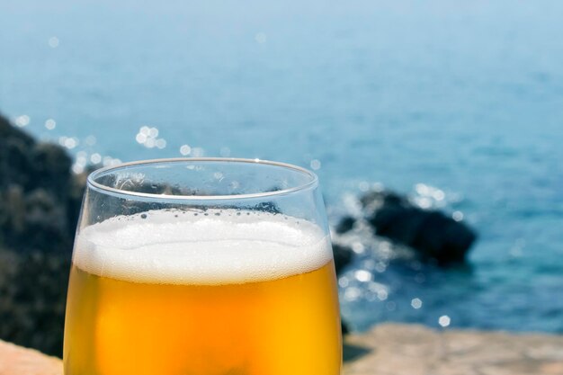 Glass of beer in the early morning on the beach