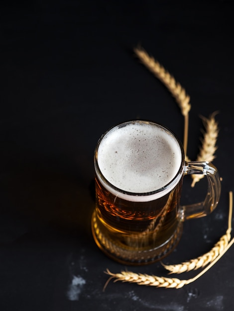 Glass beer mug on a dark table