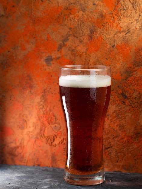 A glass of beer red ale on a concrete background