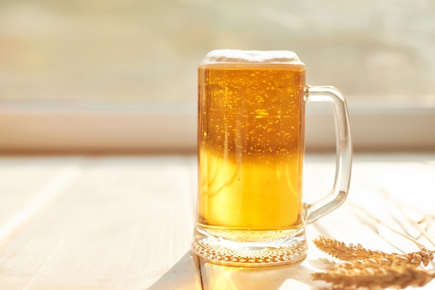 glass of beer on a white wood