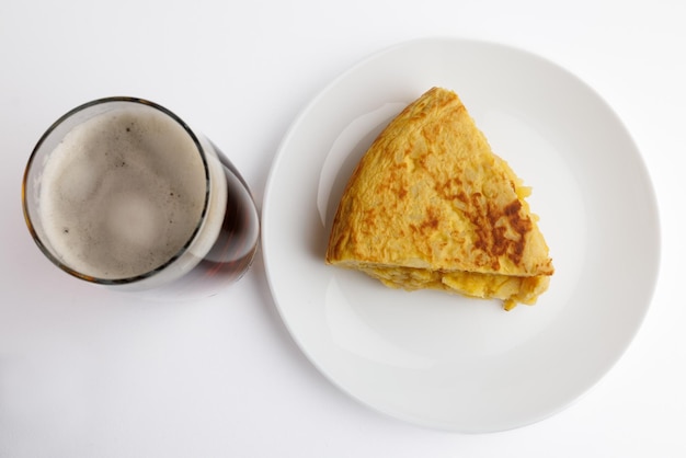 Glass of beer with potato omelette