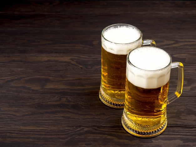 Glass of beer on wooden table with copyspace