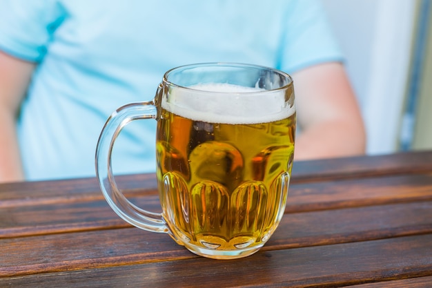 Glass of beer on wooden table