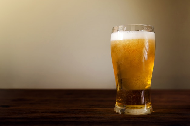 Glass of Beer on Wooden Table. 