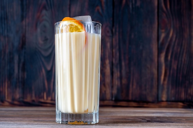 Glass of Bessie and Jessie Cocktail garnished with orange slice wheel