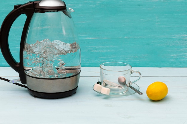 Photo glass boiling electric kettle on a wooden table.